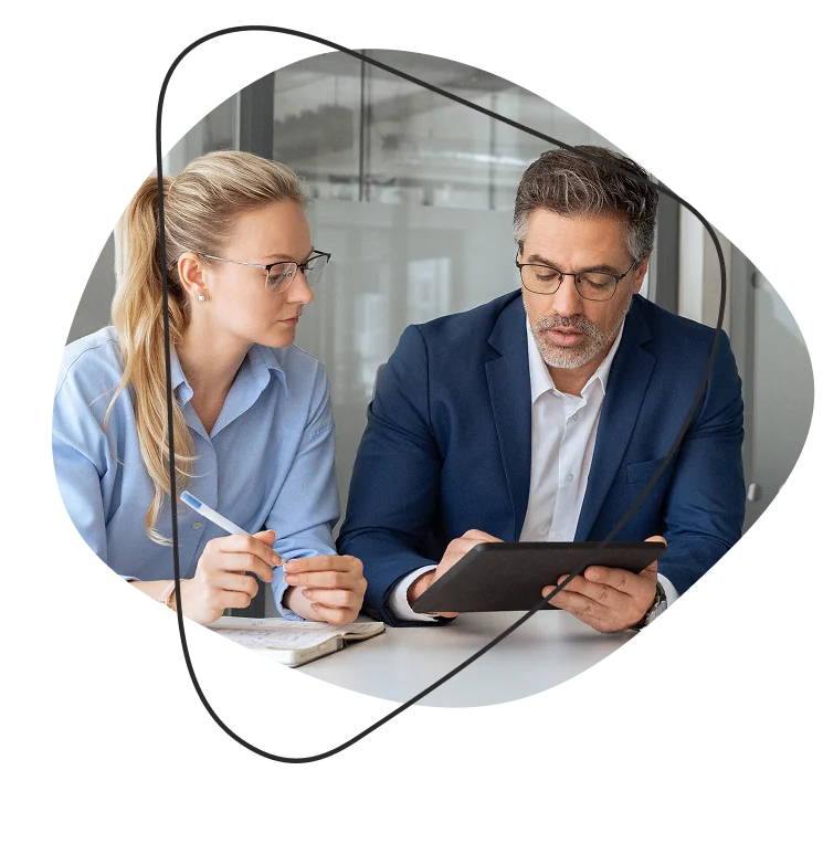 Two professionals engaging in a discussion over recruitment strategies for sales and marketing.