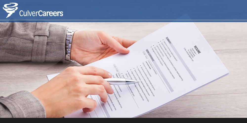 Job seeker writing their resume.
