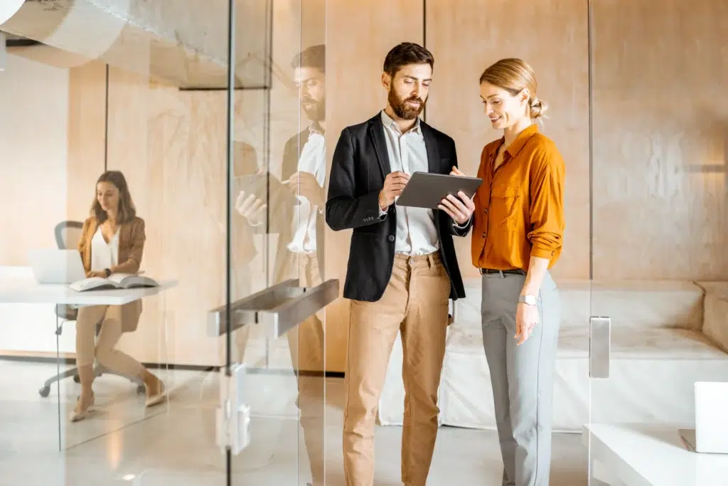 Professionals collaborating in a modern office setting focused on recruitment and talent for sales and marketing teams.