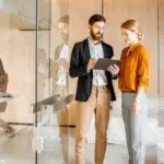 Professionals collaborating in a modern office setting focused on recruitment and talent for sales and marketing teams.