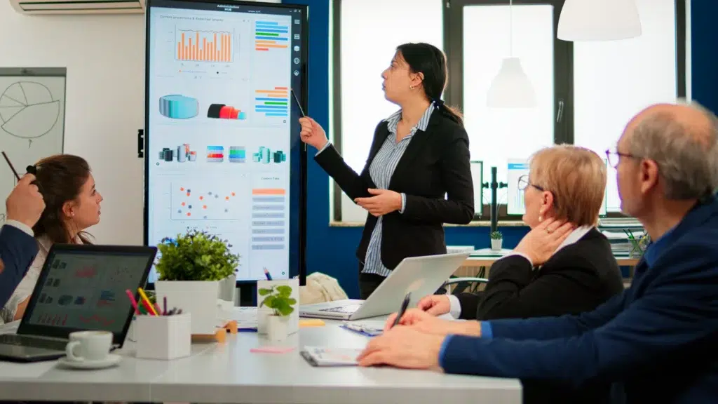 Team reviewing sales and marketing data during a presentation.