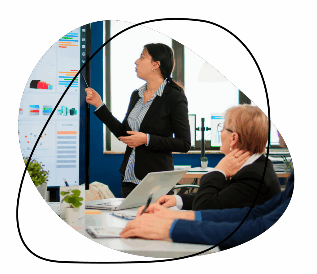 Businesswoman presenting sales data to colleagues in a meeting room.